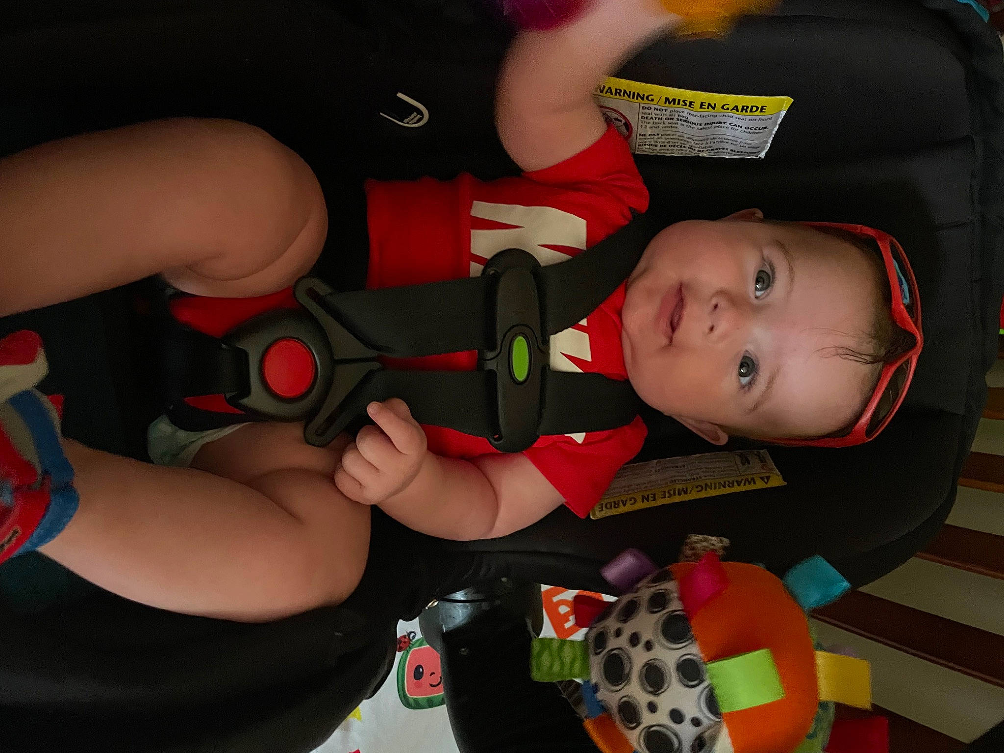 Kevin is registered to the contest to win money with this photo: auto_part, baby, baby_carriage, baby_products, baby_toddler_clothing, car_seat, carmine, child, comfort, elbow, fun, gesture, human_leg, lap, mouth, nail, person, play, thigh, thumb