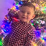bokeh, boy, candid, celebration, child, christmas_tree, cozy, cute, family_moment, festive, haircut, holiday_lights, indoors, ornaments, plaid_shirt, portrait, smile, sparkle, toddler, young_child