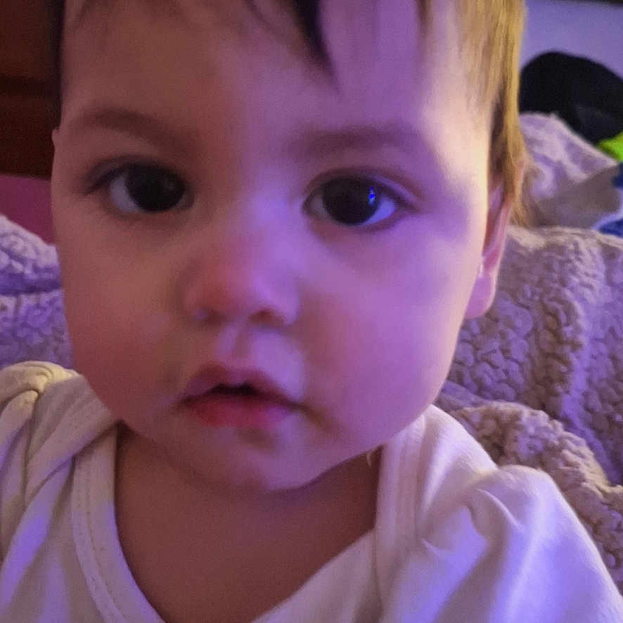 Elora joined the competition — help win amazing prizes! accessories, adult, baby, bag, bodypart, clothing, couch, face, female, finger, frown, furniture, hand, head, person, photography, portrait, sad, t_shirt, woman