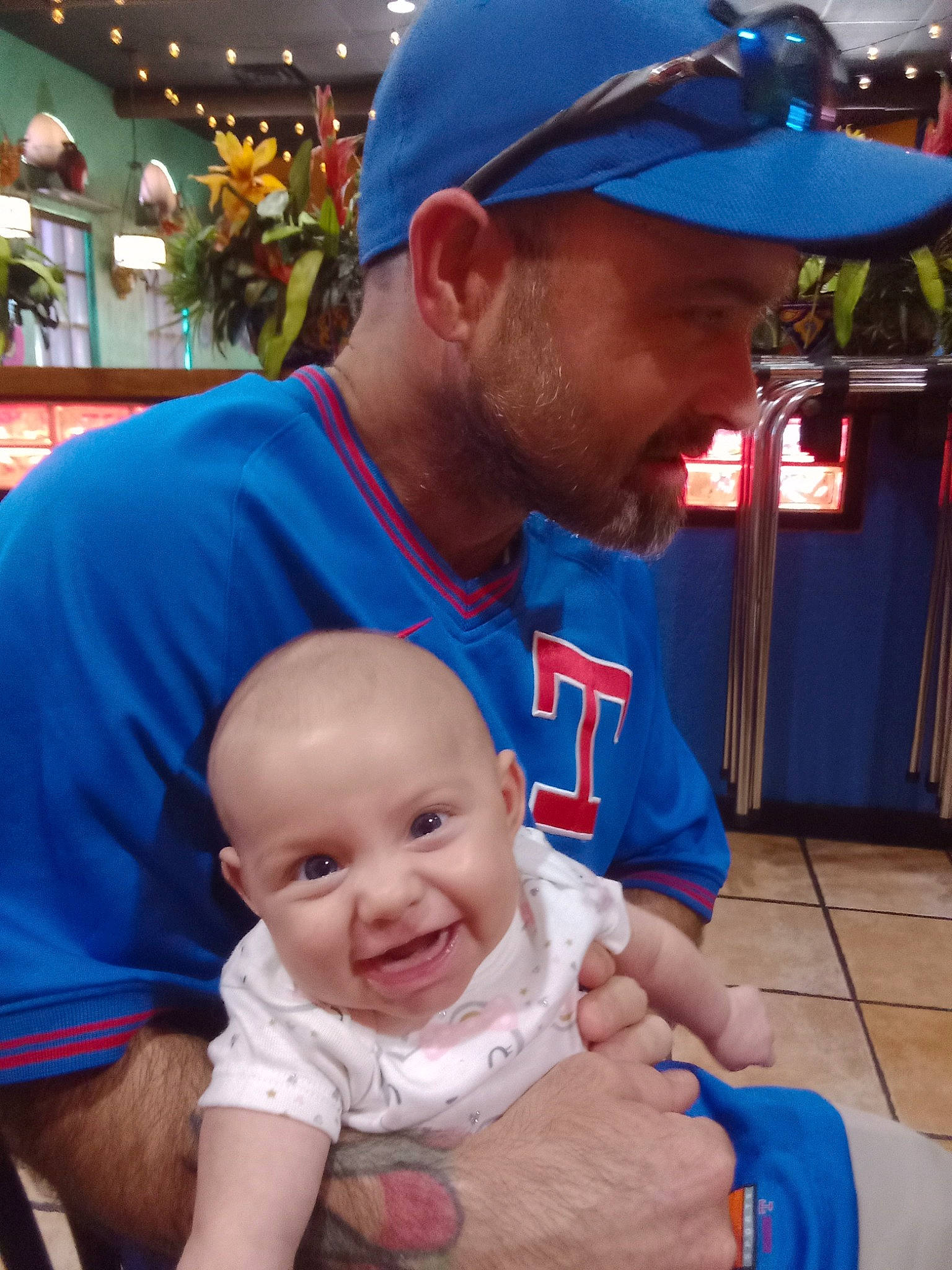 Rebecca is registered to the contest to win money with this photo: baby, baby_toddler_clothing, baseball_cap, blue, cap, child, community, fun, happy, hat, headwear, interaction, joy, leisure, organ, person, photograph, recreation, smile, snapshot