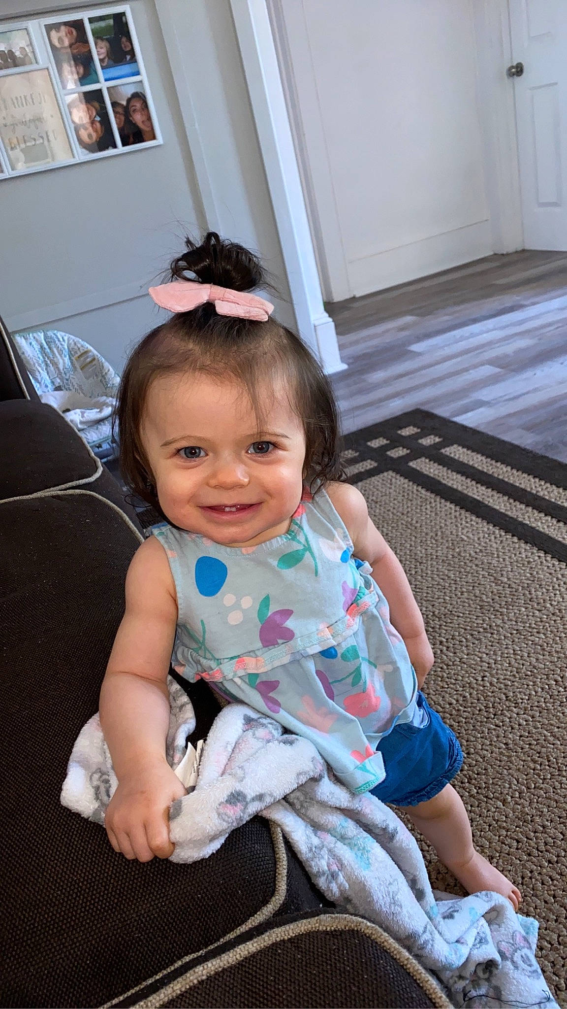 Saylor is registered to the contest to win money with this photo: baby, baby_toddler_clothing, cheek, child, comfort, door, flooring, foot, fun, happy, human_leg, joy, leisure, person, room, sitting, skin, smile, sock, standing