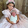 child, baby, flower_crown, pink_dress, swaddled, smile, wooden_background, rustic, sitting, tulle, headband, infant, cute, family, portrait, toddler, happy, indoor, holding, soft_lighting