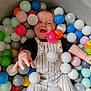 Carter joined the competition — help win amazing prizes! baby, child, ball_pit, colorful_balls, overalls, smiling, happy, indoor, playtime, toy, infant, cute, reaching_hand, striped_clothing, face, person, play, fun, joy, leisure