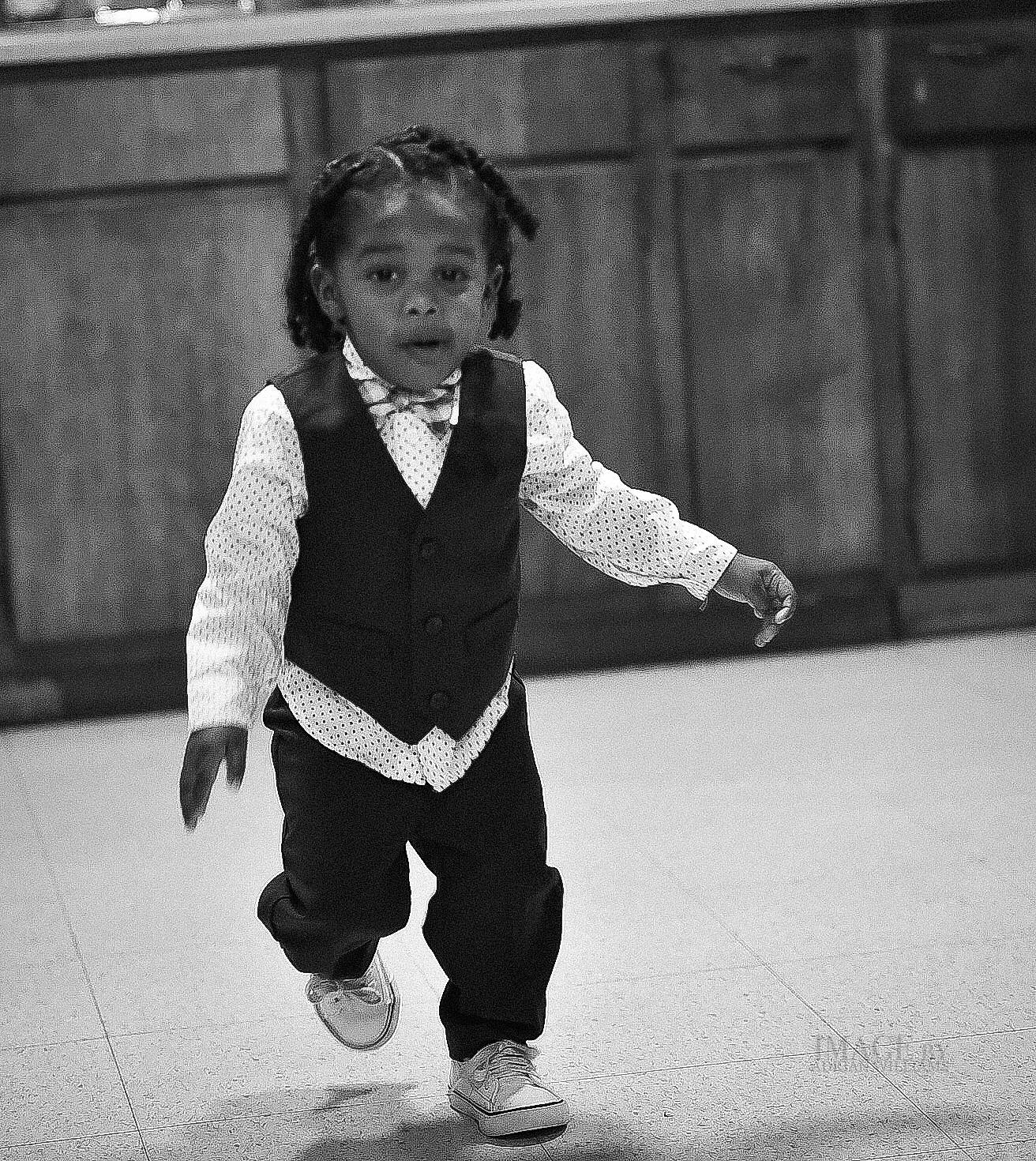 Tahj is registered to the contest to win money with this photo: black_and_white, child, clothing, door, flash_photography, footwear, fun, gesture, happy, monochrome, monochrome_photography, person, road, shoe, sleeve, sneakers, standing, street, street_fashion, style