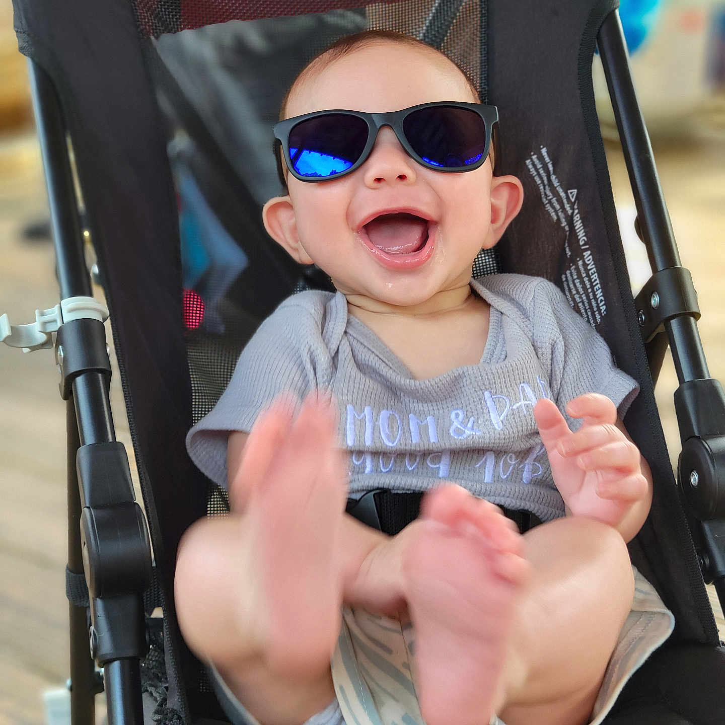 Finn joined the competition — help win amazing prizes! accessories, baby, bodypart, clothing, face, finger, glasses, hand, head, machine, mouth, outdoors, person, photography, portrait, stroller, sunglasses, t_shirt, teeth, wheel