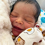 Elijah Kahlil is registered to the contest to win money with this photo: newborn, baby, sleeping, smiling, blanket, cozy, infant, cute, soft, face, wrapped, clothing, pattern, bed, peaceful, closeup, portrait, adorable, resting, child