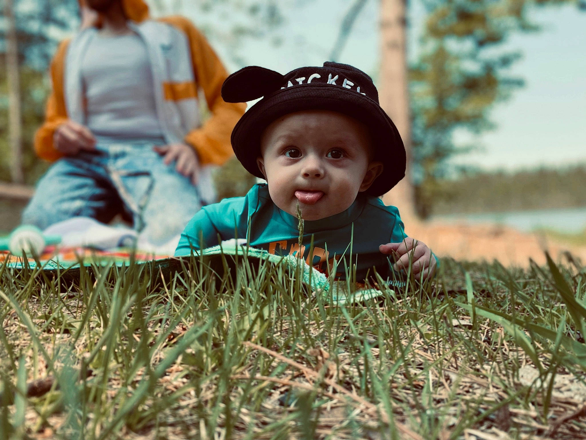 Abel joined the competition — help win amazing prizes! cap, child, facial_expression, fun, grass, grassland, happy, headwear, landscape, lawn, leaf, leisure, meadow, people_in_nature, person, plant, prairie, sitting, summer, toddler
