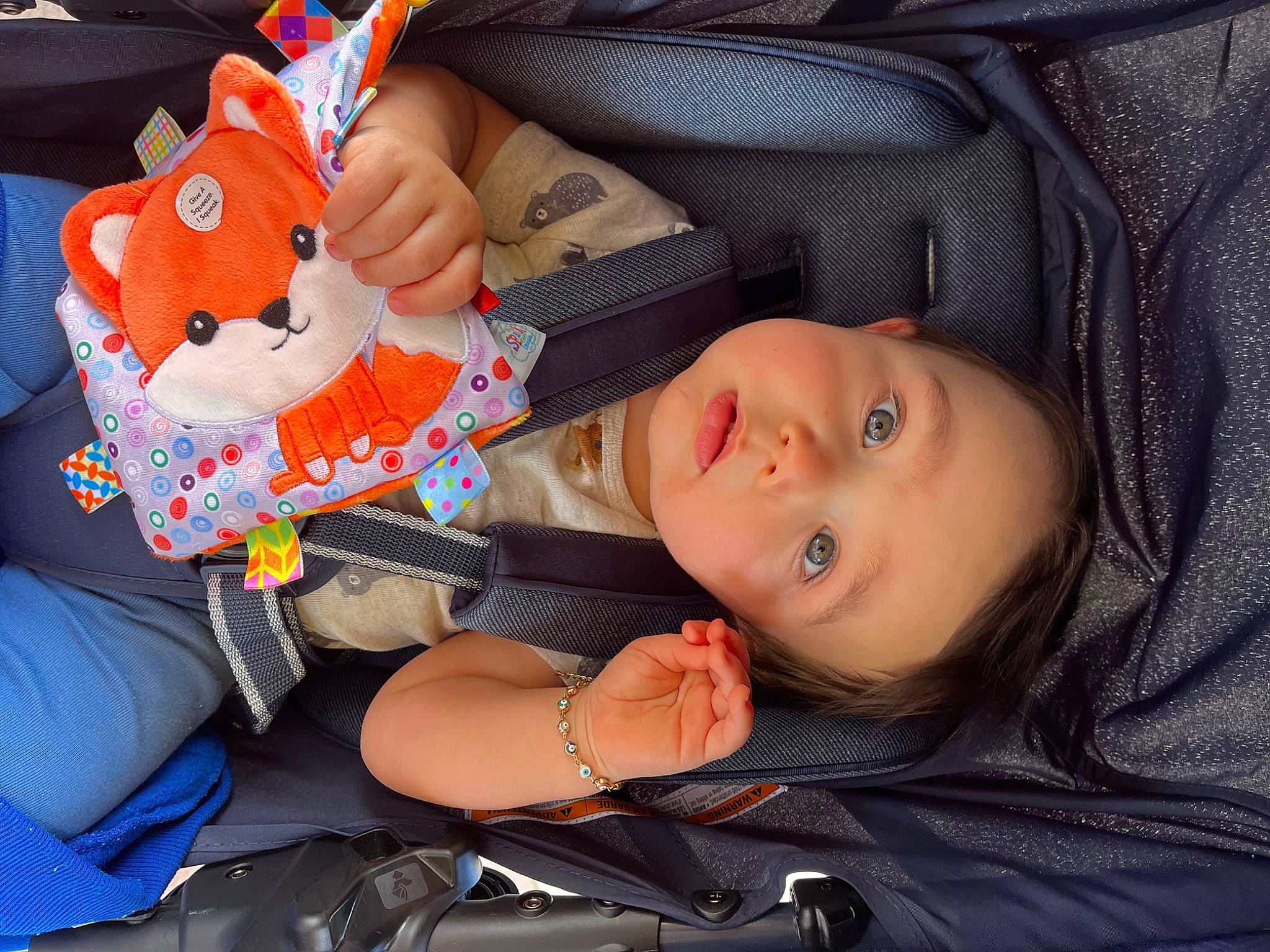 Alonzo is registered to the contest to win money with this photo: baby, baby_carriage, baby_products, baby_toddler_clothing, car_seat, cheek, child, comfort, event, fun, lap, mouth, nail, person, sitting, smile, toddler, toy, vertebrate