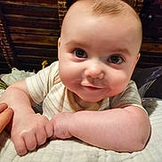 Kaiden joined the competition — help win amazing prizes! baby, infant, smile, face, hands, blanket, striped_shirt, cute, closeup, portrait, skin, head, eyes, cheeks, person, indoors, soft, resting, happy, young_child