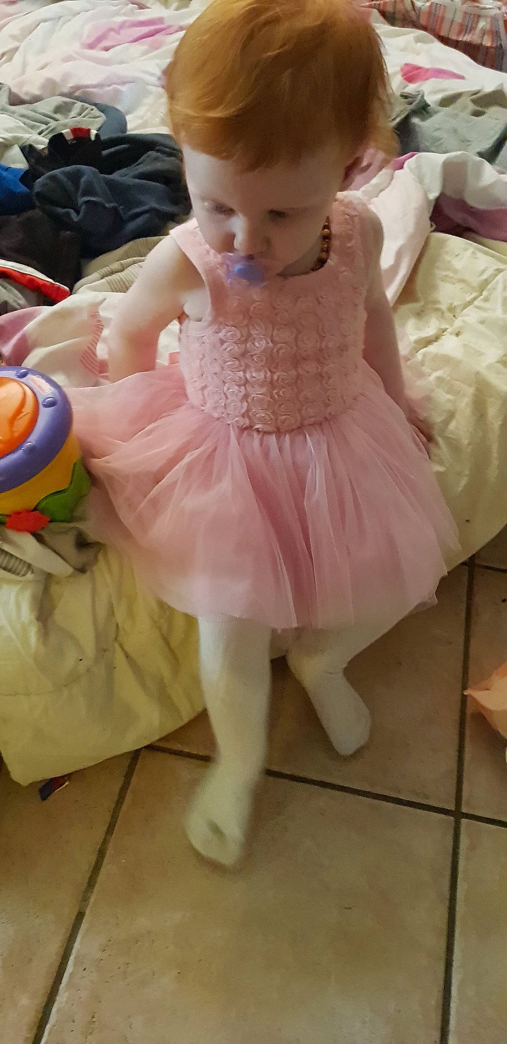 Kylie is registered to the contest to win money with this photo: baby, ballet_tutu, child, clothing, costume, doll, dress, person, pink, shoe, toddler, toy