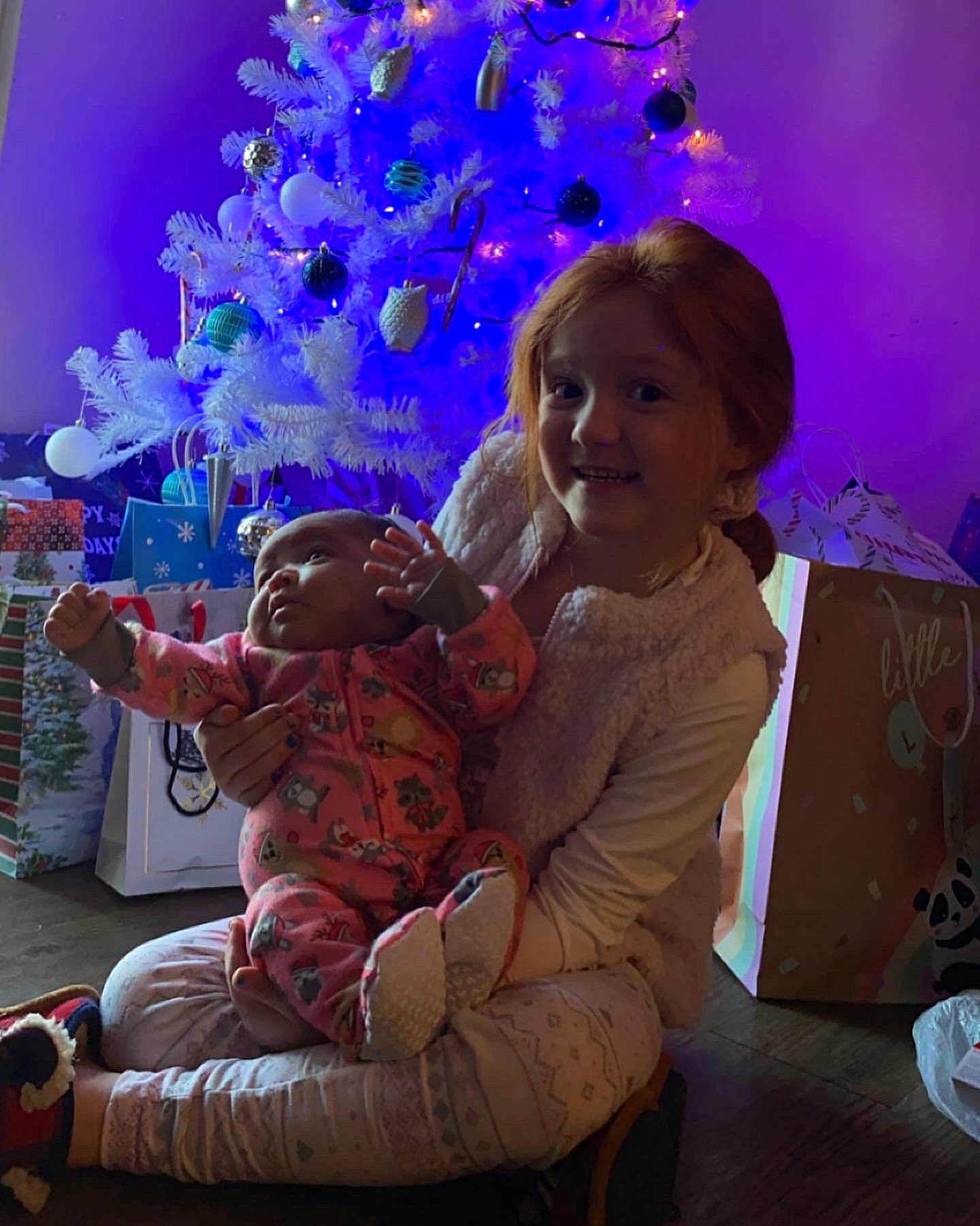 Avianna joined the competition — help win amazing prizes! beauty, child, christmas_decoration, christmas_eve, christmas_ornament, christmas_tree, event, fun, happy, holiday, holiday_ornament, joy, lap, ornament, person, pink, plant, purple, toddler, toy