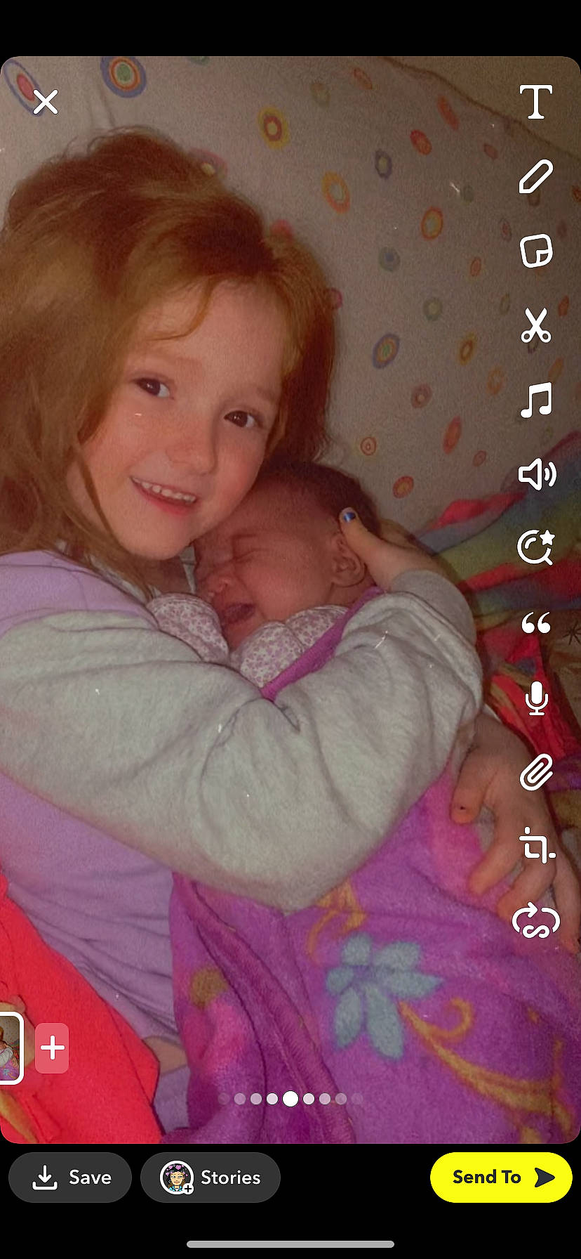 Avianna is registered to the contest to win money with this photo: brown_hair, calendar, cheek, child, eyelash, fun, gesture, happy, joy, lip, magenta, mouth, nose, pattern, person, photo_caption, pink, room, sitting, skin