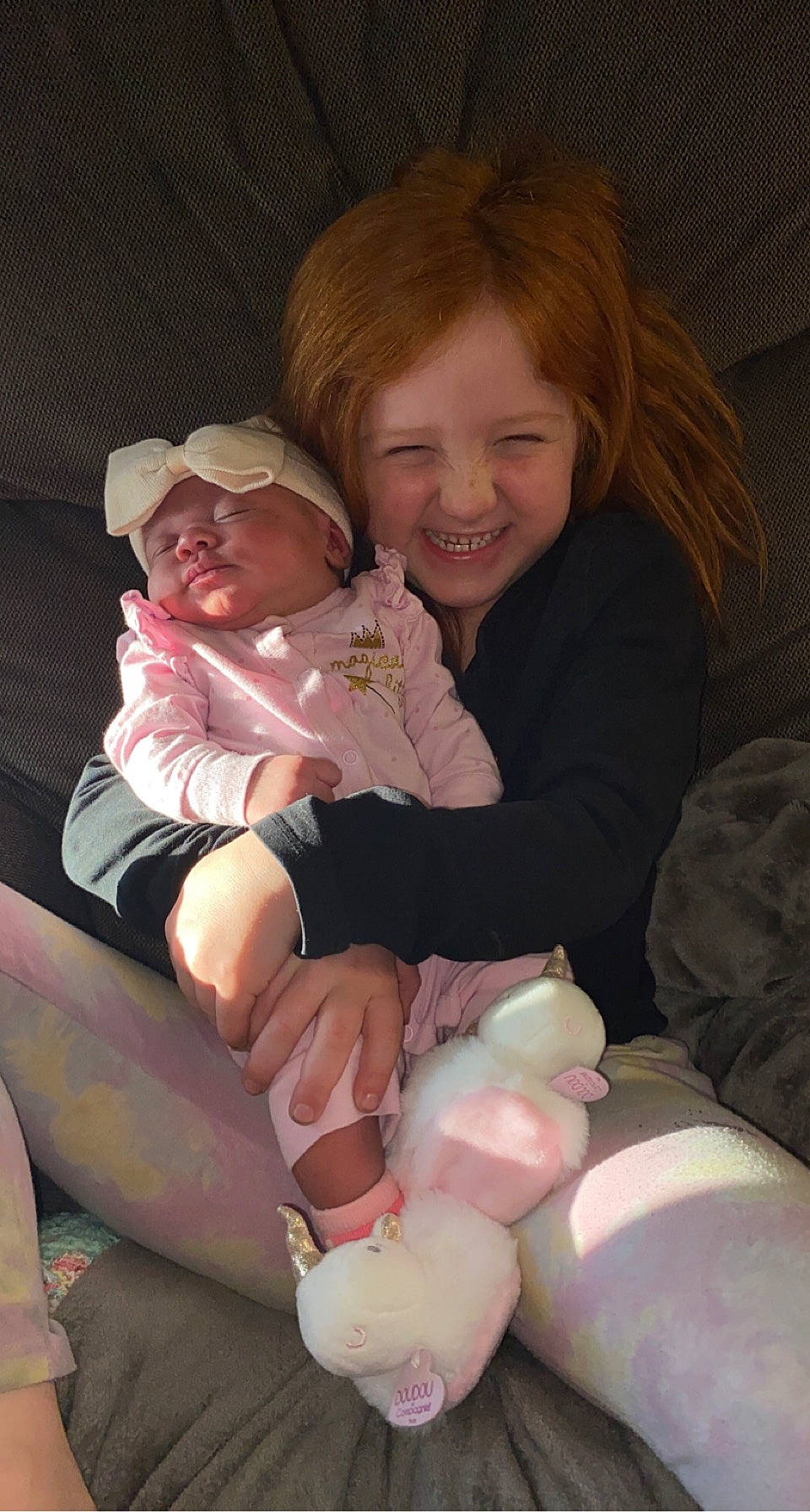 Avianna is registered to the contest to win money with this photo: baby_toddler_clothing, cheek, comfort, eye, face, finger, gesture, hand, happy, head, human_body, joy, lap, leg, mouth, organ, person, pink, skin, smile