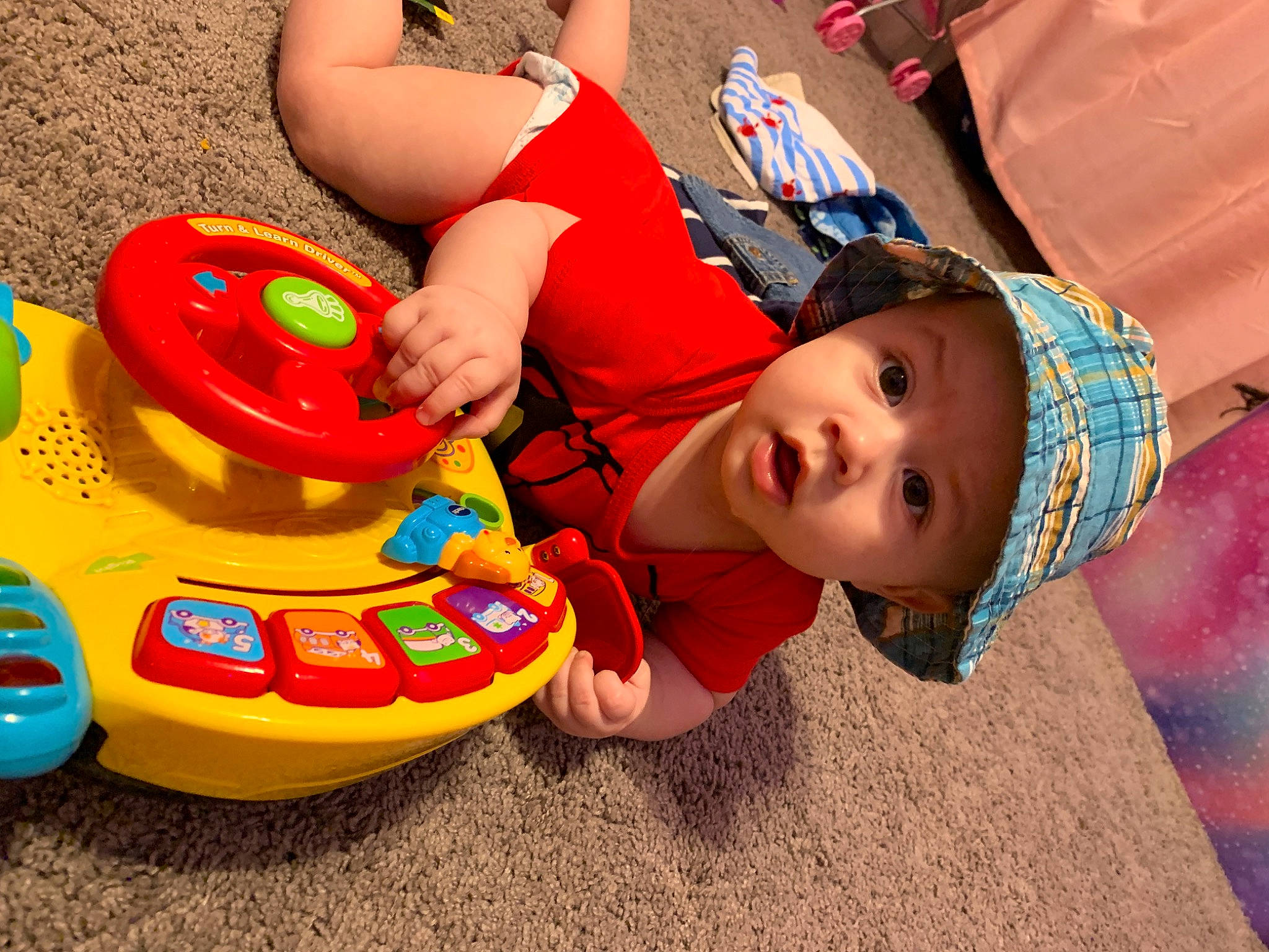 Zavian joined the competition — help win amazing prizes! baby, baby_playing_with_toys, baby_products, baby_toys, child, fun, grass, happy, headwear, leisure, person, plastic, play, recreation, riding_toy, sitting, smile, surprise, tire, toddler