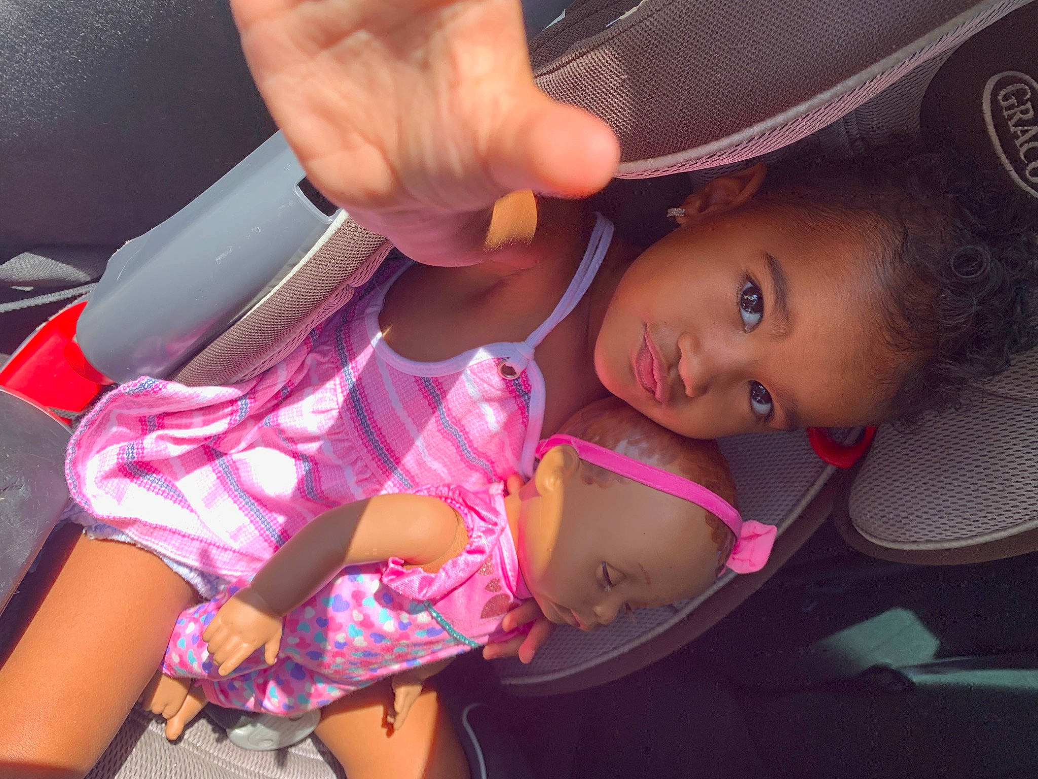 Jayde is registered to the contest to win money with this photo: auto_part, cap, car_seat, cool, elbow, finger, fun, happy, hat, lip, magenta, mouth, person, pink, skin, smile, steering_wheel, thigh, thumb, toddler