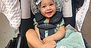 Syilynne joined the competition — help win amazing prizes! baby, infant, car_seat, headband, smiling, toy, plush_blanket, child, happy, seatbelt, indoor, clothing, person, cute, colorful, playful, comfort, sitting, small_child, accessory
