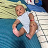 baby, child, infant, bed, pillow, blanket, towel, blue, striped_onesie, foot, hand, curious, indoor, skin, person, cute, soft, fabric, relaxed, lying_down