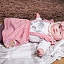 Eliza a rejoint le concours — aidez-le/la à gagner de superbes lots ! baby, infant, pink_dress, headband, flower, blanket, wooden_floor, blue_eyes, cute, portrait, lying_down, soft_texture, warm, child, toddler, indoors, clothing, person, baby_girl, resting