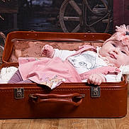 Eliza participe au concours pour gagner de l'argent avec cette photo : baby, infant, suitcase, pink_clothing, headband, flower, wooden_floor, pumpkin, rustic_background, cozy, portrait, child, cute, indoor, soft_lighting, smiling, person, lying_down, warm_colors, vintage