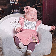 Eliza participe au concours pour gagner de l'argent avec cette photo : autumn, baby, cartoon_clothing, child, chubby_cheeks, cozy, curious_expression, cute, deer_print, headwear, indoor, infant, pink_headband, plush_chair, portrait, pumpkins, rustic_background, sitting, soft_furniture, wooden_floor