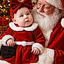 baby, beard, celebration, child, christmas, cute, decorations, festive, gift_boxes, glasses, happy, holiday, indoor, lights, portrait, red_bow, red_clothing, santa_claus, smile, white_fur_trim