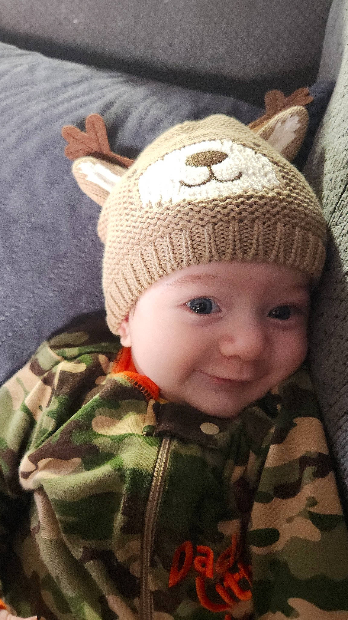 Ryder is registered to the contest to win money with this photo: baby, baby_toddler_clothing, cap, cheek, chin, eye, eyebrow, forehead, grass, head, headgear, headwear, iris, knit_cap, nose, person, skin, sleeve, smile, toddler
