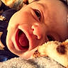 baby, smiling, blanket, cozy, face, infant, child, closeup, portrait, happy, cute, soft, warm, comfort, sleepwear, cuddle, expression, indoor, person, toddler