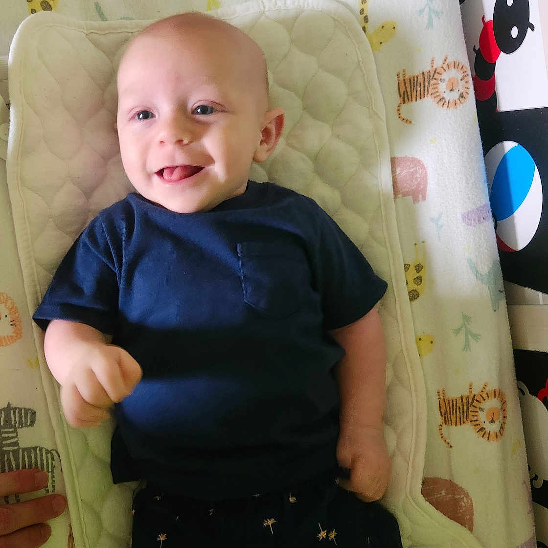 Elijah joined the competition — help win amazing prizes! baby, bed, bodypart, clothing, crib, cushion, face, finger, furniture, hand, head, homedecor, indoors, infantbed, person, photography, portrait, shorts, standing, t_shirt