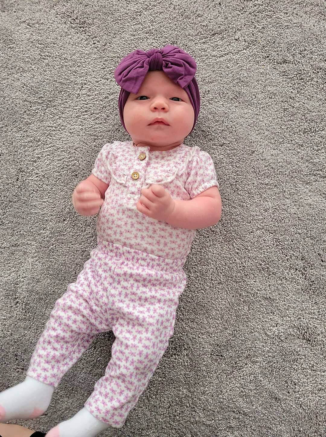Kelsey joined the competition — help win amazing prizes! art, baby, baby_toddler_clothing, beanie, cap, child, face, fashion_accessory, flooring, head, headwear, human_body, knit_cap, linens, magenta, pattern, peach, person, pink, sleeve