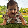 toddler, child, grass, outdoor, floral_dress, crawling, greenery, palm_trees, sunny, nature, portrait, baby, hands, face, cute, summer, garden, daylight, expression, curious
