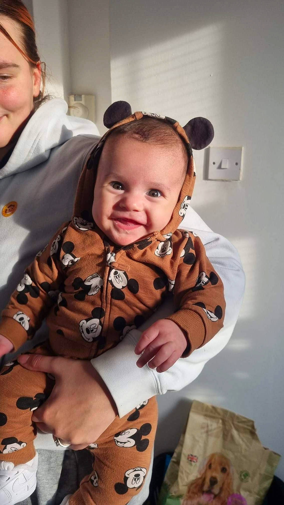 Archie is registered to the contest to win money with this photo: baby, baby_toddler_clothing, child, costume, event, facial_expression, fashion_accessory, fun, hair, happy, head, iris, jewellery, pattern, person, sitting, skin, sleeve, smile, thumb