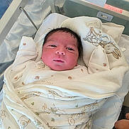 Muhammad is registered to the contest to win money with this photo: baby, bassinet, bed, blanket, clothing, cute, face, hand, hospital, human, indoors, infant, newborn, patterned, person, resting, skin, sleeping, soft, wrapped