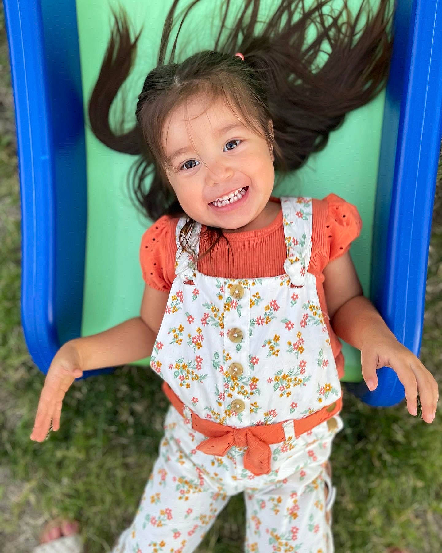 Alison is registered to the contest to win money with this photo: baby_toddler_clothing, blue, child, facial_expression, fun, grass, green, hairstyle, happy, joy, leisure, organ, people_in_nature, person, photograph, pink, sleeve, smile, standing, toddler