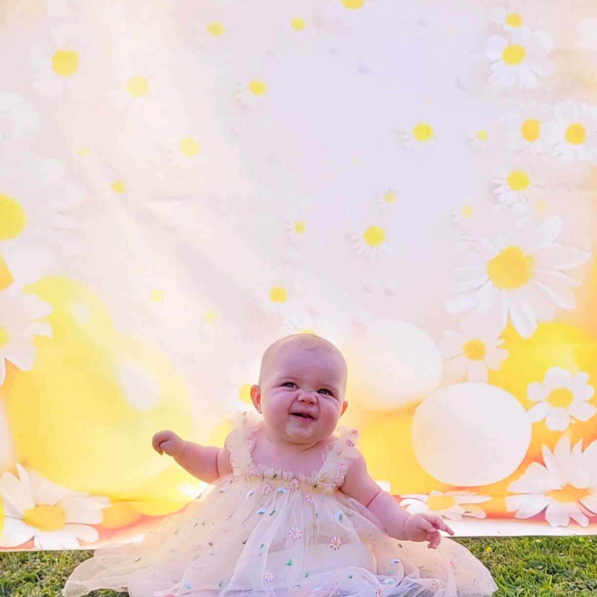 Ambre participe au concours pour gagner de l'argent avec cette photo : baby, background, balloon, celebration, child, cute, dress, floral, flower_pattern, grass, greenery, happy, infant, nature, outdoor, portrait, sitting, smile, sunlight, yellow