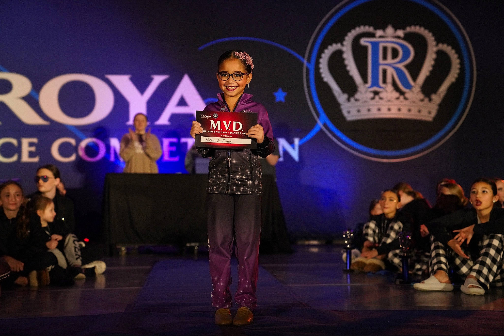 Aleannah is registered to the contest to win money with this photo: design, electric_blue, entertainment, event, face, fashion, fashion_design, font, joy, lighting, logo, music, music_artist, performance, performance_art, performing_arts, person, public_event, purple, social_group