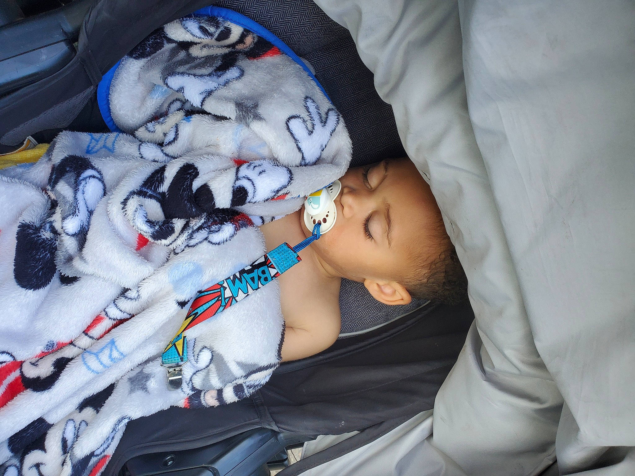 Damion is registered to the contest to win money with this photo: arm, auto_part, automotive_design, baby, baby_carriage, baby_products, car_seat, carmine, child, comfort, hand, hat, linens, nap, person, plastic, sitting, sleep, textile, toddler
