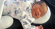 Nalani joined the competition — help win amazing prizes! newborn, baby, sleeping, onesie, clothing, cute, peaceful, infant, face, head, pink, white, pattern, soft, cushion, bed, rest, child, person, portrait