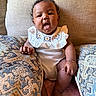 Novèn joined the competition — help win amazing prizes! baby, bracelet, child, couch, curly_hair, cute, embroidery, fabric, foot, hand, indoors, infant, pattern, pillow, portrait, seated, skin, soft, texture, white_clothing