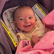 Liliana is registered to the contest to win money with this photo: baby, smiling, infant, pink_blanket, minnie_mouse, car_seat, warning_label, cute, happy, child, portrait, indoors, clothing, fabric, seat, young_child, face, person, baby_clothes, blanket