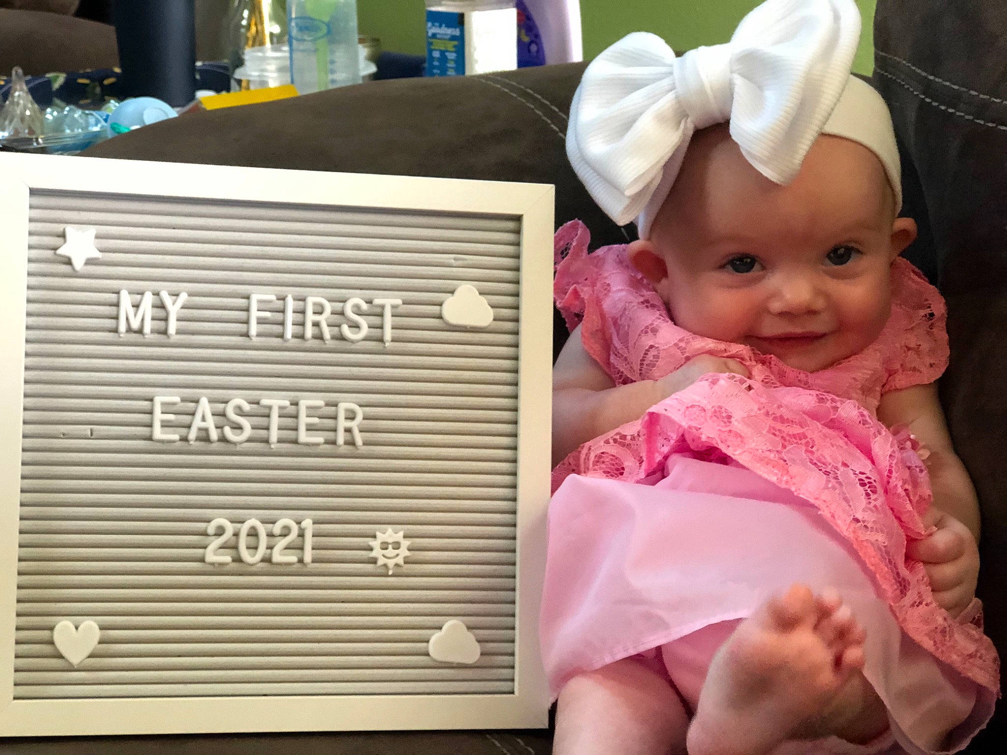 Hartley is registered to the contest to win money with this photo: baby, baby_products, baby_toddler_clothing, cap, cheek, child, font, foot, fun, happy, headwear, linens, magenta, pattern, person, play, room, sitting, sleeve, smile