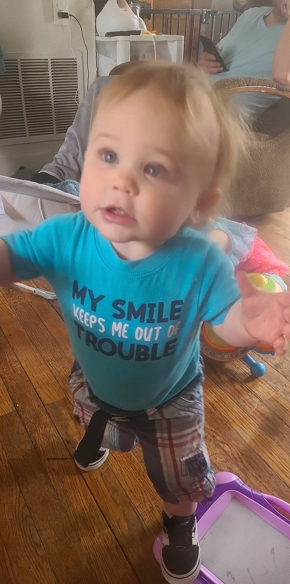 Rease is registered to the contest to win money with this photo: baby, baby_toddler_clothing, cheek, child, chin, finger, flooring, fun, happy, hardwood, mouth, nose, person, sitting, skin, sleeve, smile, t_shirt, thumb, toddler