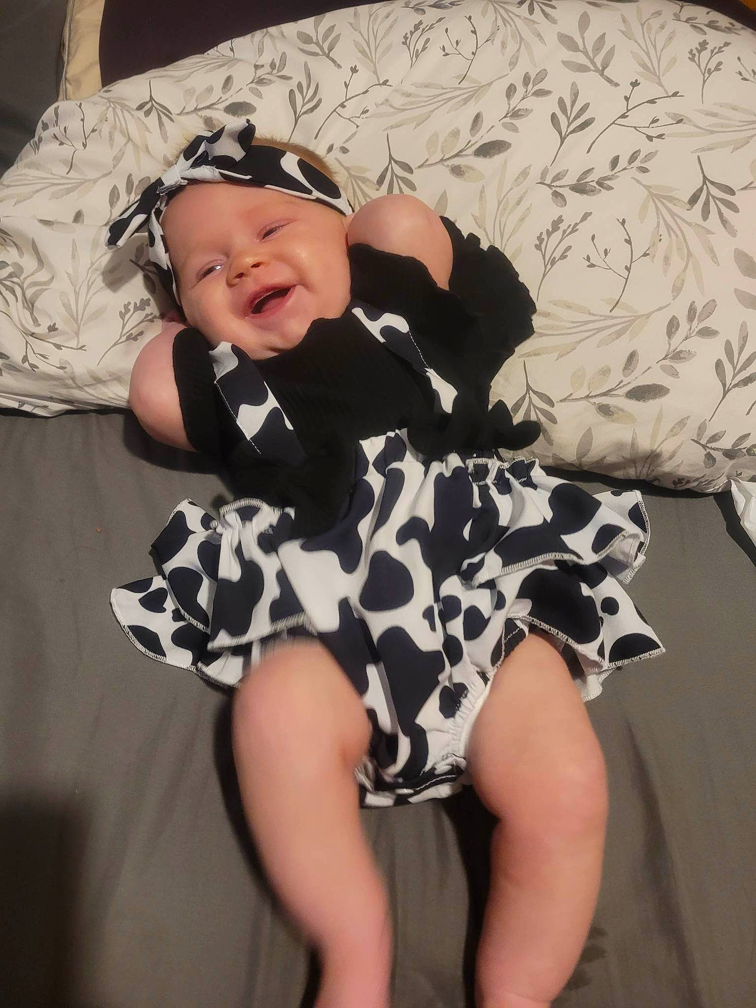 Davinna is registered to the contest to win money with this photo: baby, baby_toddler_clothing, child, costume, day_dress, fashion_accessory, happy, hat, headgear, headwear, human_leg, knee, pattern, person, sitting, sleeve, smile, sun_hat, t_shirt, textile