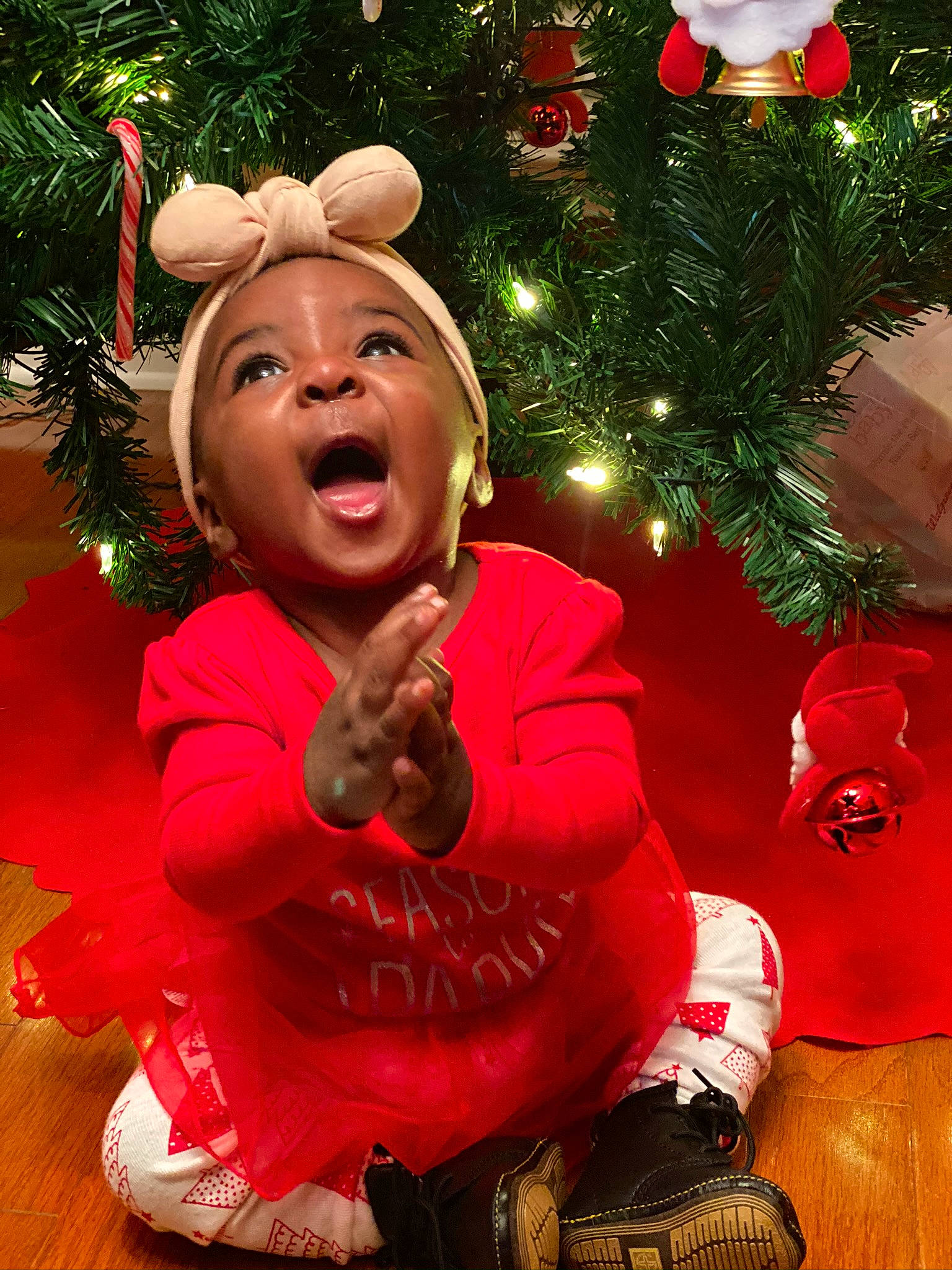 Devyn is registered to the contest to win money with this photo: child, christmas, christmas_decoration, christmas_eve, christmas_ornament, christmas_tree, event, facial_expression, fir, fun, happy, headwear, holiday, holiday_ornament, human_body, interior_design, laugh, ornament, person, red