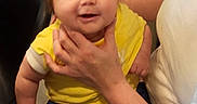 Briiella-Rose joined the competition — help win amazing prizes! baby, child, smiling, yellow_shirt, blue_pants, hair, indoor, person, adult_hand, happy, cute, face, sitting, clothing, holding, portrait, infant, home, joy, expression