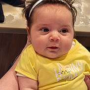 Briiella-Rose joined the competition — help win amazing prizes! baby, infant, child, yellow_shirt, headband, flower, cute, face, skin, arm, person, indoor, holding, clothing, expression, young, portrait, closeup, human, babywear
