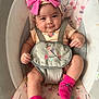Zoey is registered to the contest to win money with this photo: baby, infant, pink_bow, baby_seat, floral_pattern, smiling, straps, socks, cute, child, headband, indoors, comfort, person, seat, legs, happy, small_child, apparel, closeup