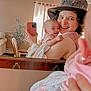 Nova is registered to the contest to win money with this photo: baby, adult, mirror, selfie, hat, skull, blanket, smile, happy, indoor, curtains, phone, reflection, hand, person, furniture, chair, plant, wall, window