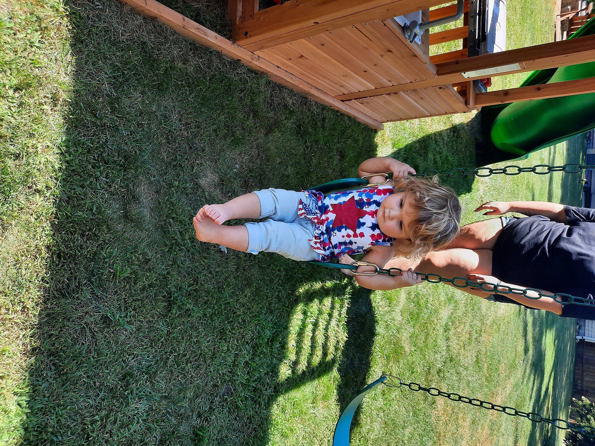 Aubrey is registered to the contest to win money with this photo: artificial_turf, backyard, child, fun, grass, groundcover, happy, lawn, leisure, outdoor_play_equipment, people_in_nature, person, plant, play, recreation, shrub, smile, t_shirt, toddler, tree