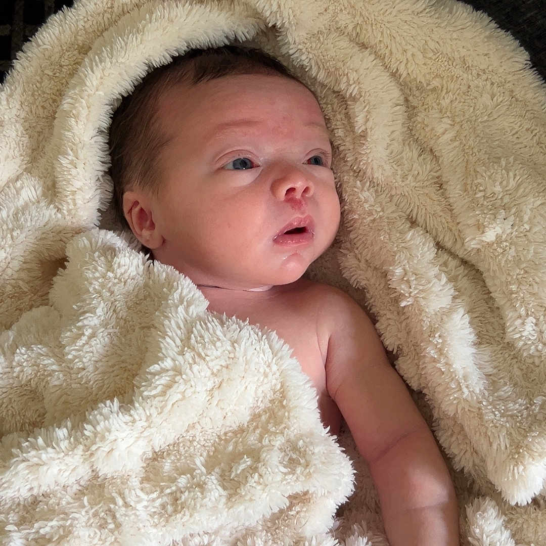 Mia joined the competition — help win amazing prizes! baby, blanket, bodypart, face, finger, furniture, hand, head, newborn, person, photography, portrait, quilt, towel