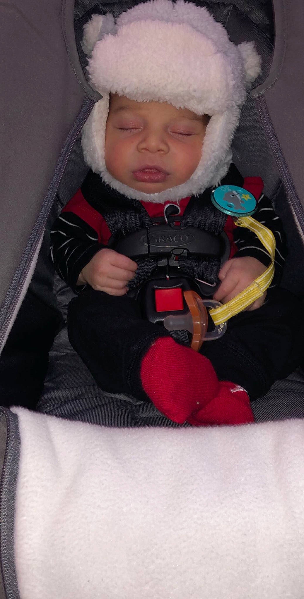 Quinton is registered to the contest to win money with this photo: baby, baby_carriage, baby_products, car_seat, cheek, child, fun, person, play, product, smile, snow, toddler, winter